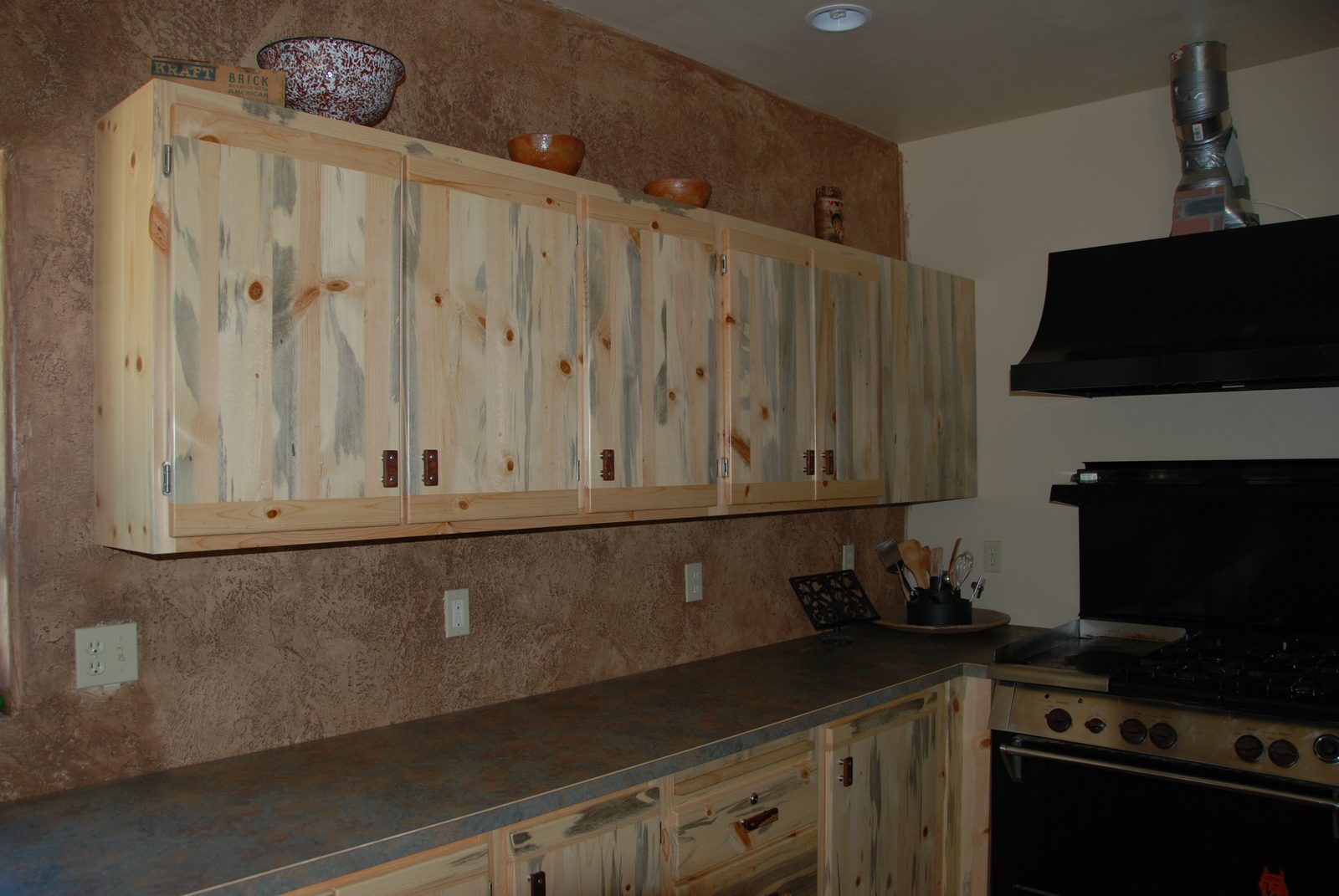 Blue pine kitchen cabinetry installed in a finished room